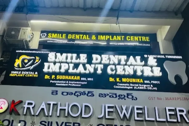 Smile Dental & Implant Centre clinic signboard featuring Dr. P. Sudhakar and Dr. K. Nounika dental implant and cosmetic dentistry services